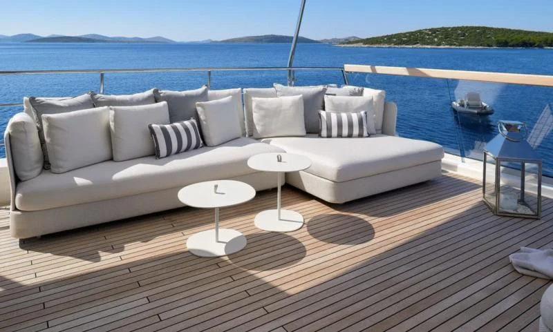 a couch and a table on a deck overlooking a body of water aboard 2011 SANLORENZO SD92 FLYBRIDGE Yacht for Sale
