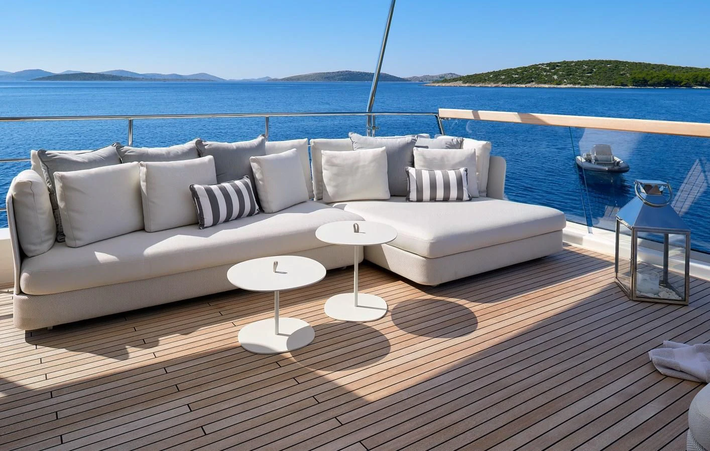 a couch and table on a deck overlooking a body of water aboard 2011 SANLORENZO SD92 FLYBRIDGE Yacht for Sale