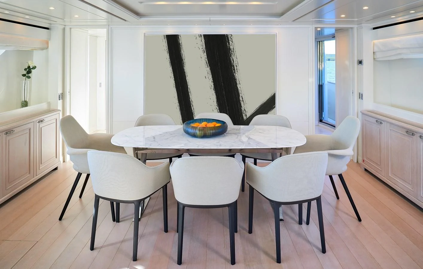 a table with chairs around it aboard 2011 SANLORENZO SD92 FLYBRIDGE Yacht for Sale