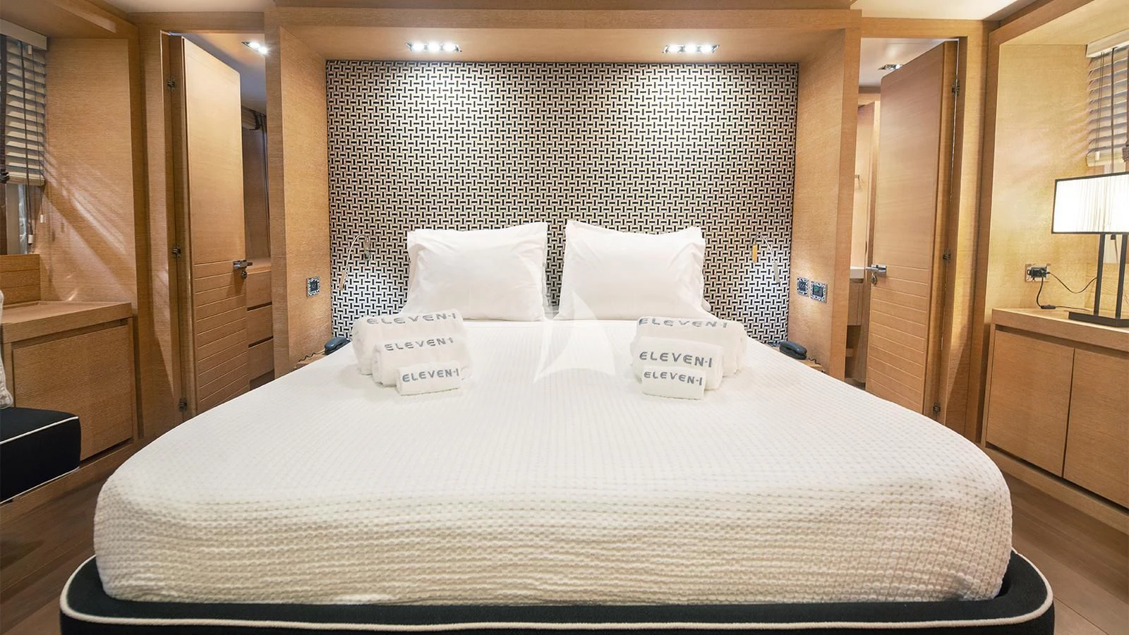 a bed with white sheets aboard ELEVEN I Yacht for Sale