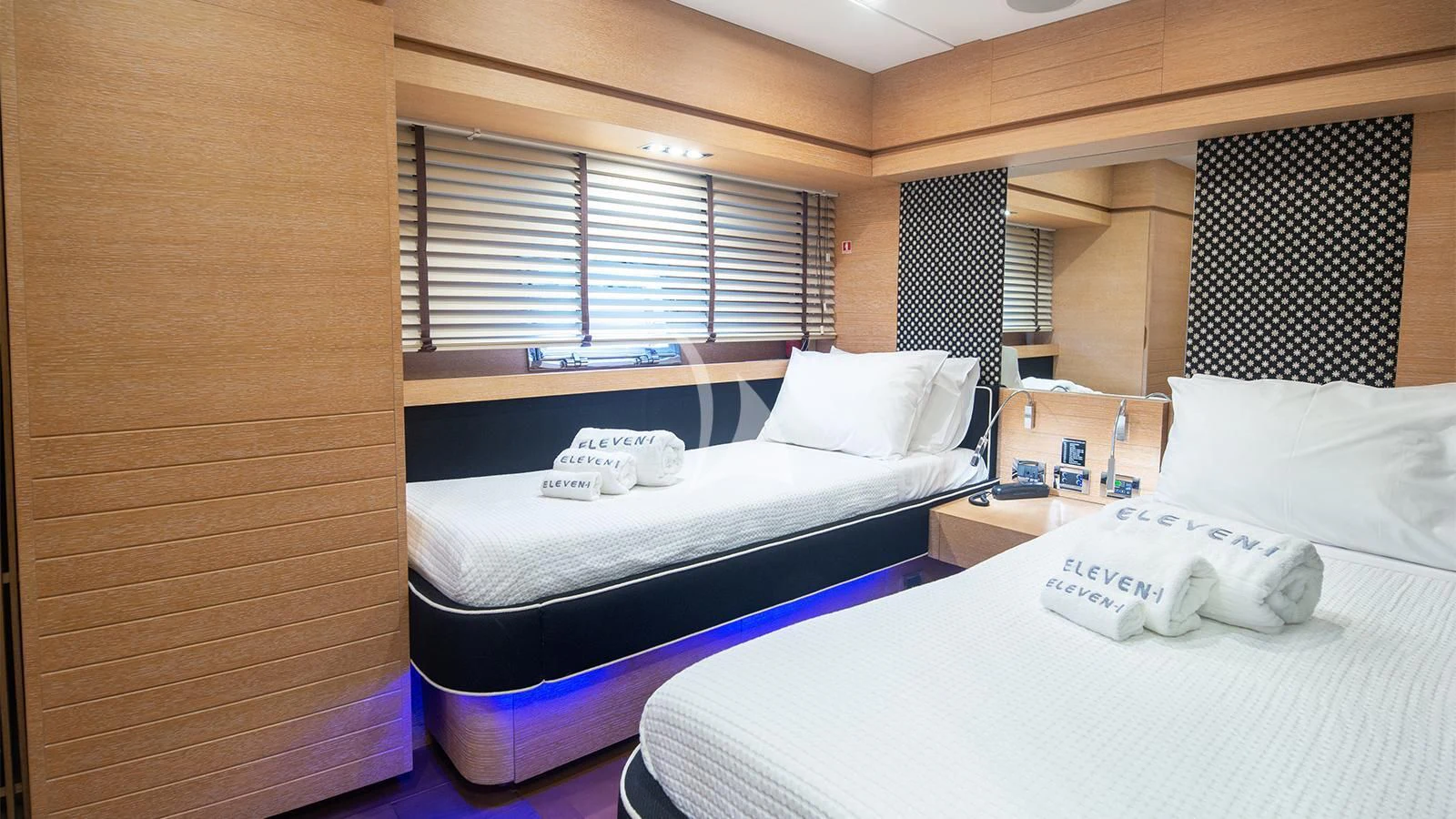 a room with beds and a dresser aboard ELEVEN I Yacht for Sale