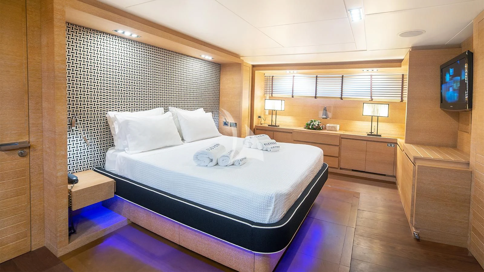 a room with a bed and a tv aboard ELEVEN I Yacht for Sale