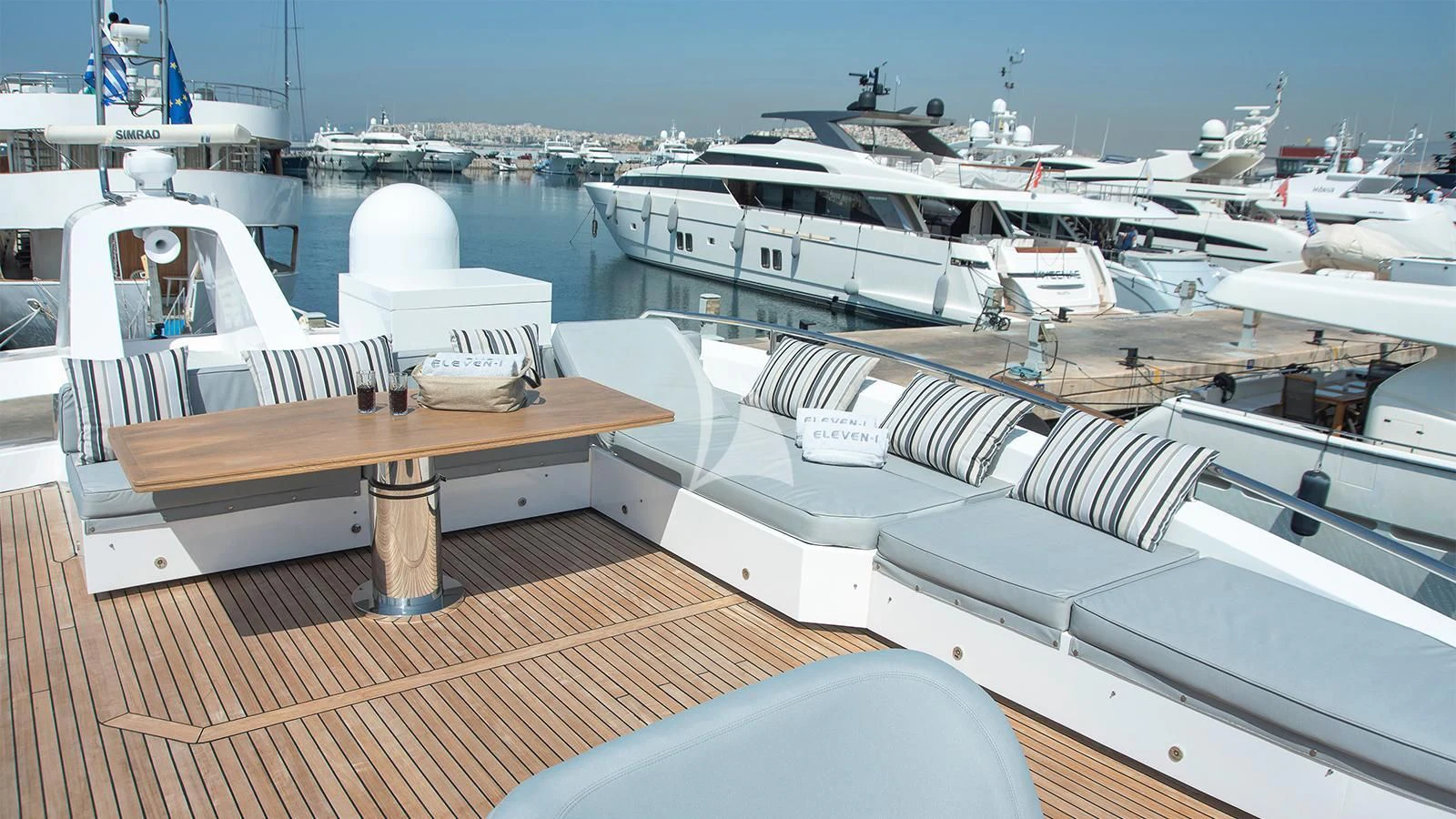 a deck with a table and boats aboard ELEVEN I Yacht for Sale