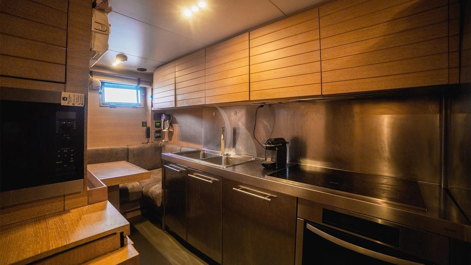 a kitchen with wooden cabinets aboard ELEVEN I Yacht for Sale