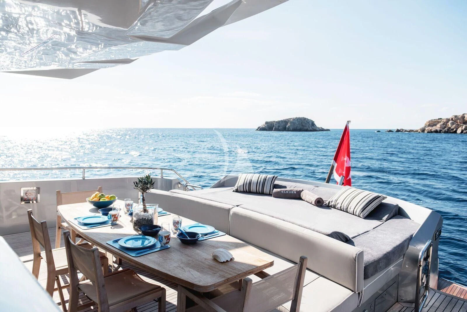 a table and chairs on a beach aboard ELEVEN I Yacht for Sale