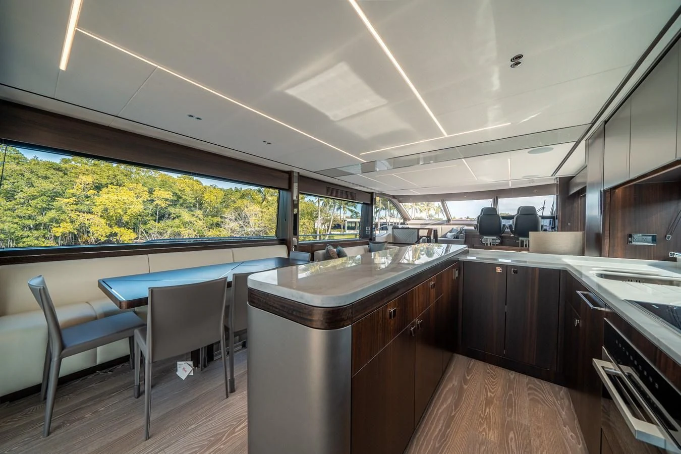 a kitchen with a bar and a table and chairs aboard 88 YACHT Yacht for Sale