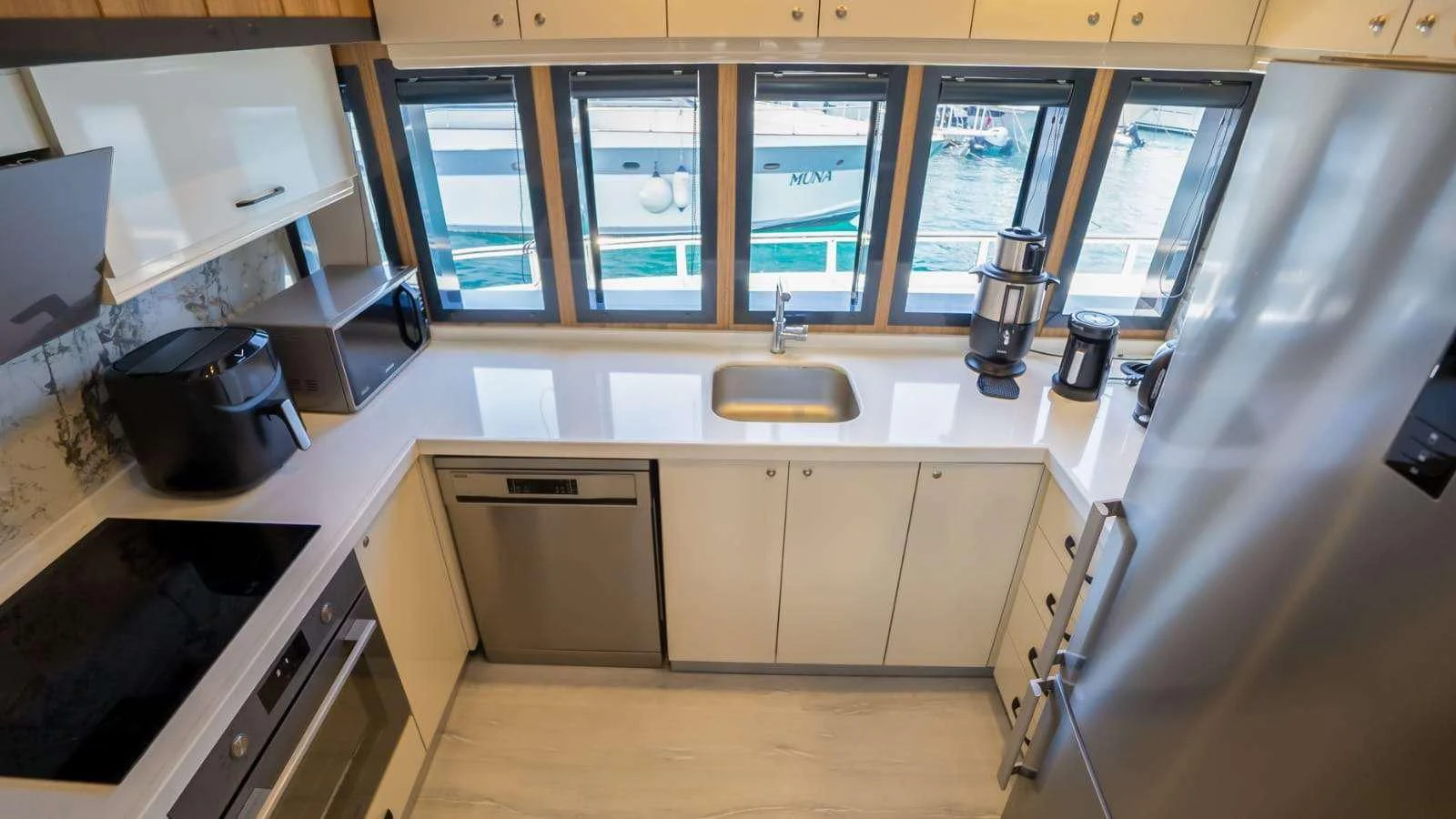 a kitchen with white cabinets aboard 88 YACHT Yacht for Sale