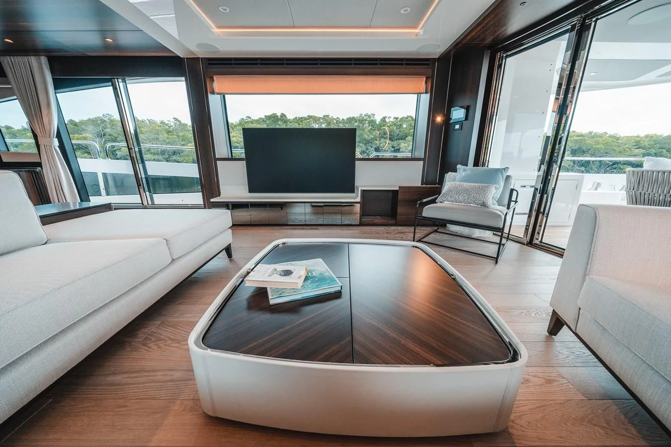 a living room with a table and couches aboard 88 YACHT Yacht for Sale