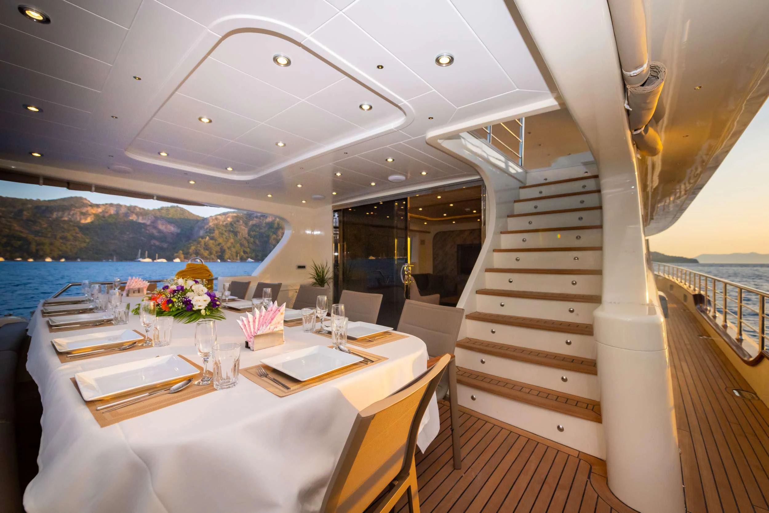 a table with chairs and a view of the ocean aboard 88 YACHT Yacht for Sale