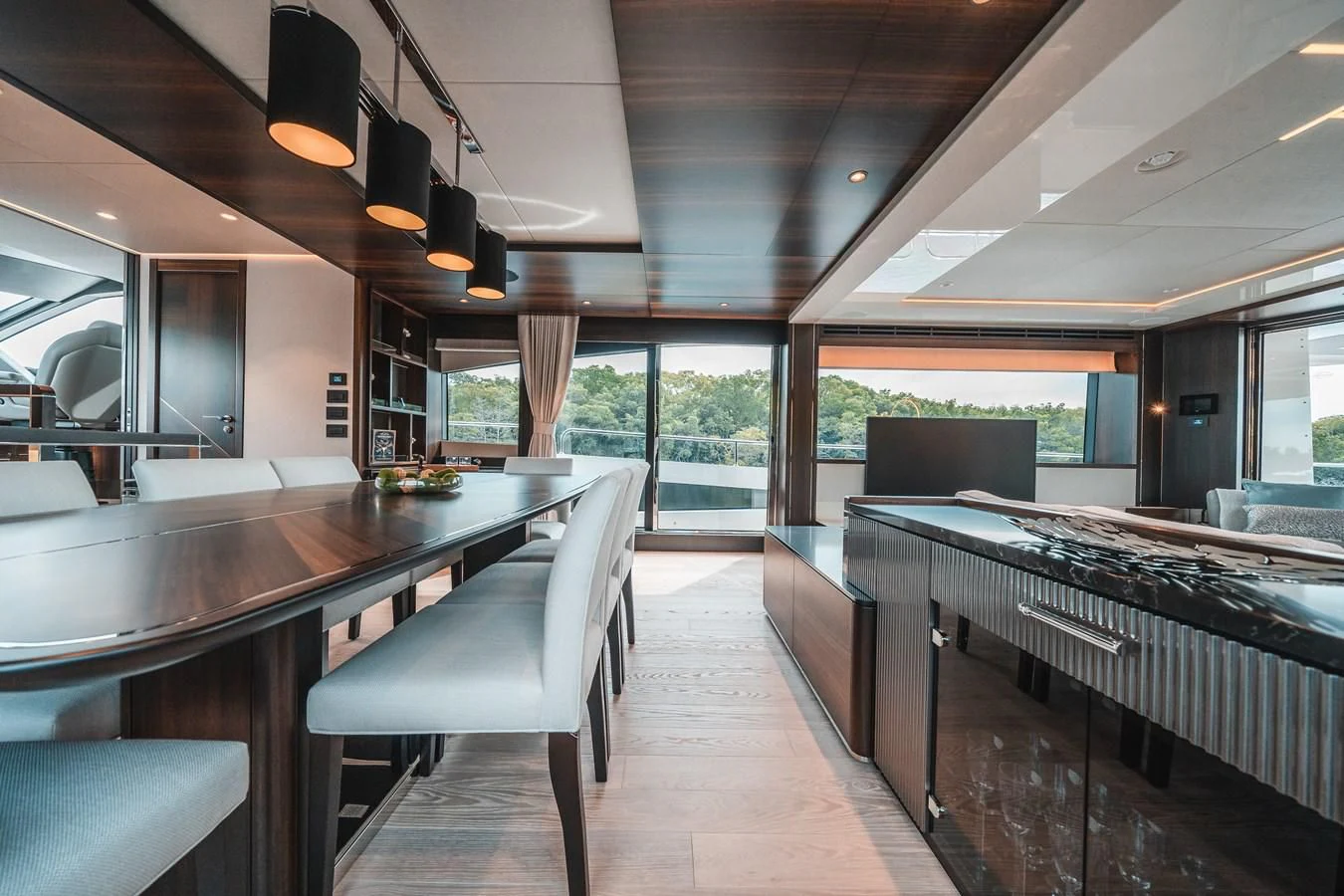 a large kitchen with a bar and bar seating aboard 88 YACHT Yacht for Sale