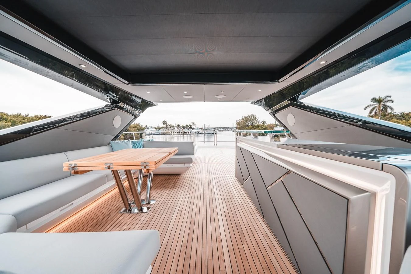 a wooden deck with a table and chairs on it aboard 88 YACHT Yacht for Sale