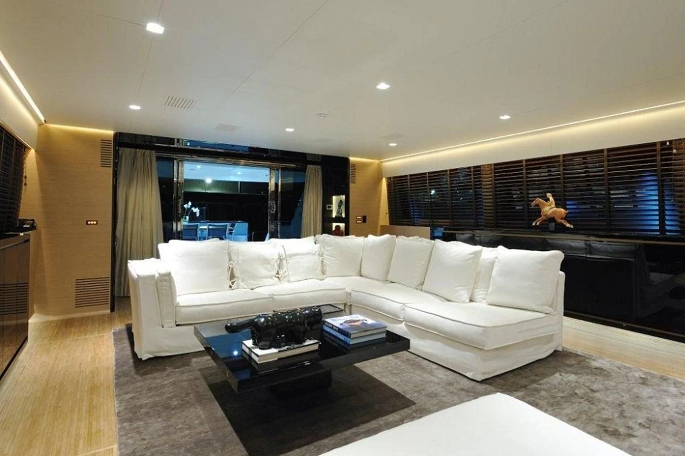 a living room with a large white couch and a large window aboard BY BUBANNY Yacht for Sale