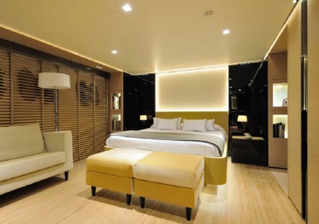 a bedroom with a bed and a desk aboard BY BUBANNY Yacht for Sale
