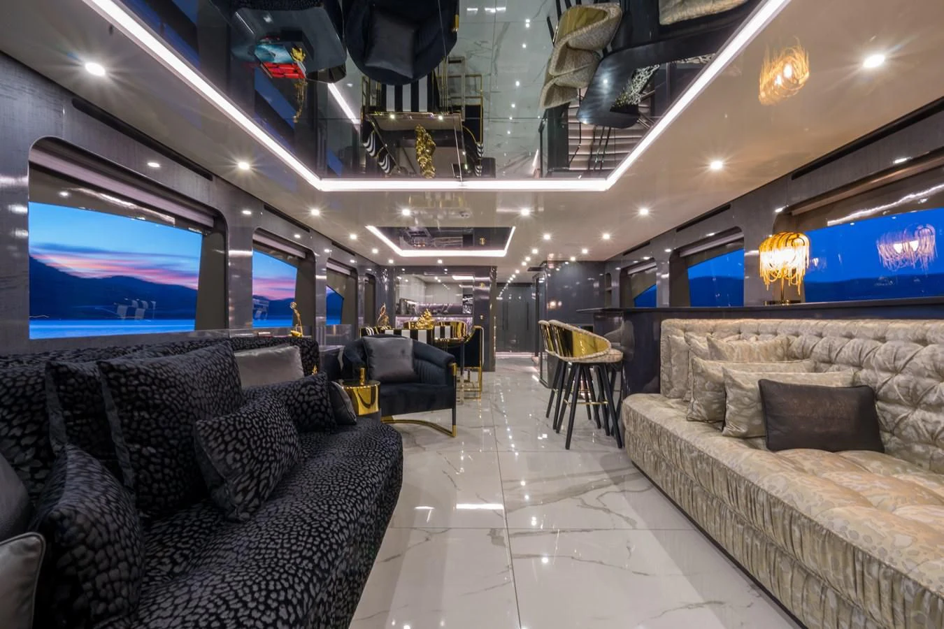 a room with couches and a television aboard NOAM Yacht for Sale
