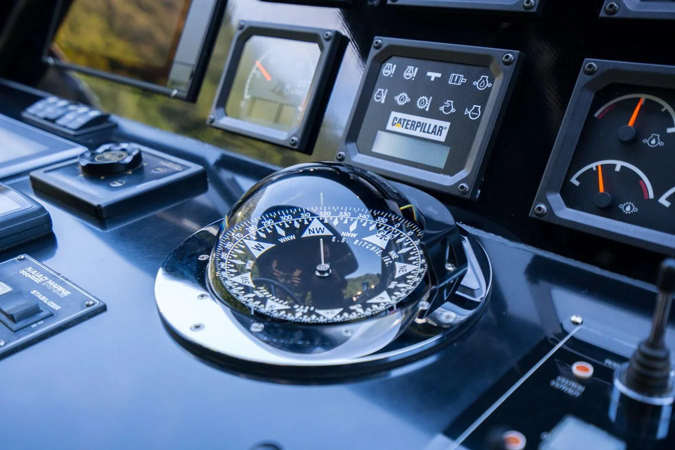 a compass on a table aboard NOAM Yacht for Sale