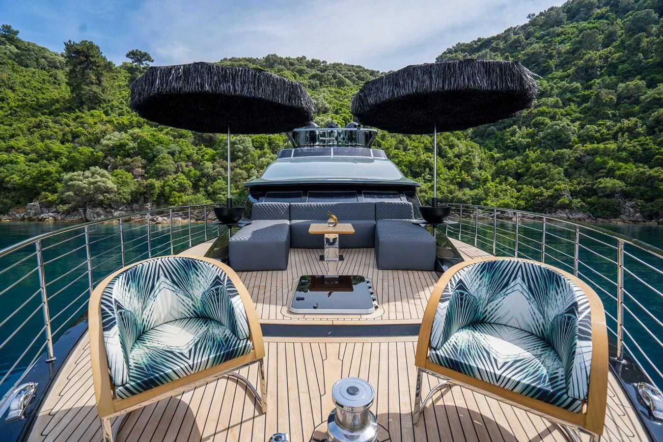 a deck with chairs and umbrellas aboard NOAM Yacht for Sale