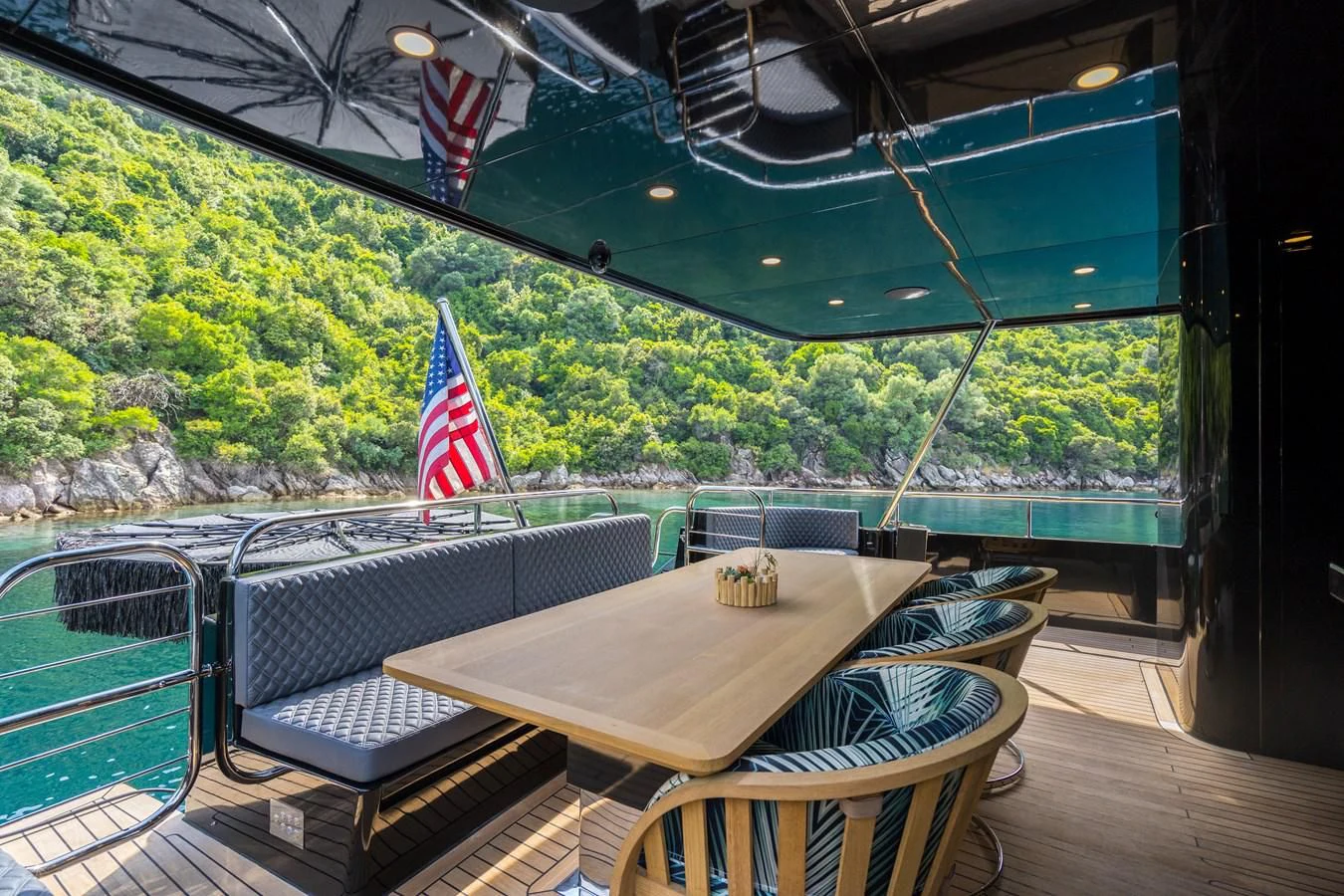 a table and chairs on a deck aboard NOAM Yacht for Sale