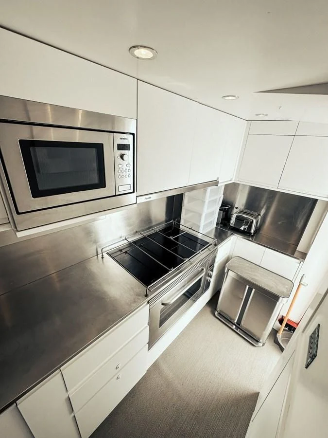 a kitchen with a stove and oven aboard LAZIZA Yacht for Sale