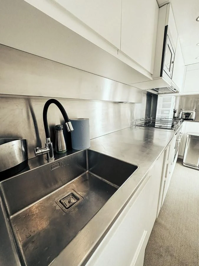 a kitchen with stainless steel appliances aboard LAZIZA Yacht for Sale
