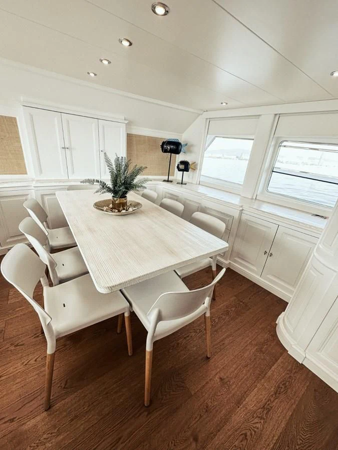 a white dining table in a room aboard LAZIZA Yacht for Sale