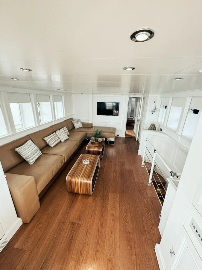 a living room with a wood floor aboard LAZIZA Yacht for Sale