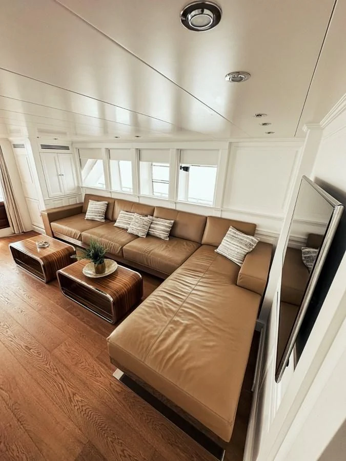 a living room with a couch and a coffee table aboard LAZIZA Yacht for Sale
