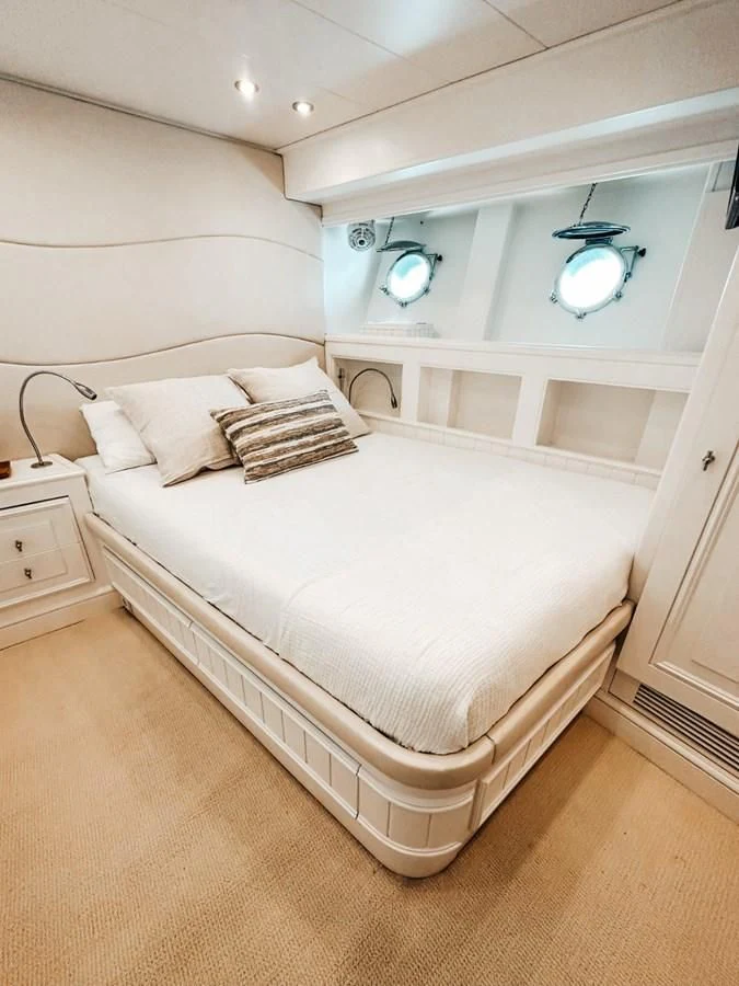 a white bed with a white bed aboard LAZIZA Yacht for Sale