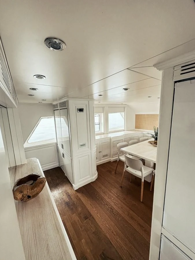 a room with a table and chairs aboard LAZIZA Yacht for Sale