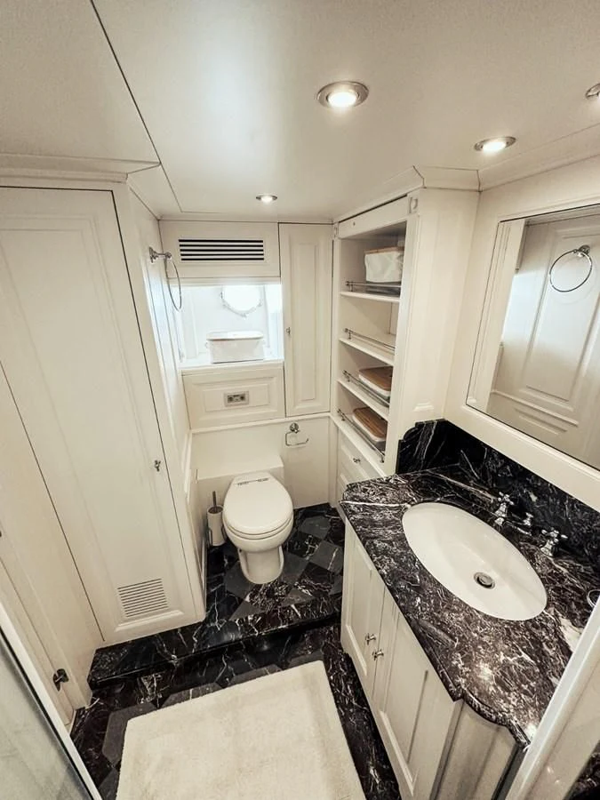 a bathroom with a sink toilet and a mirror aboard LAZIZA Yacht for Sale