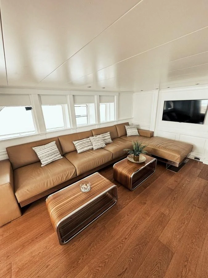 a living room with a couch and a coffee table aboard LAZIZA Yacht for Sale