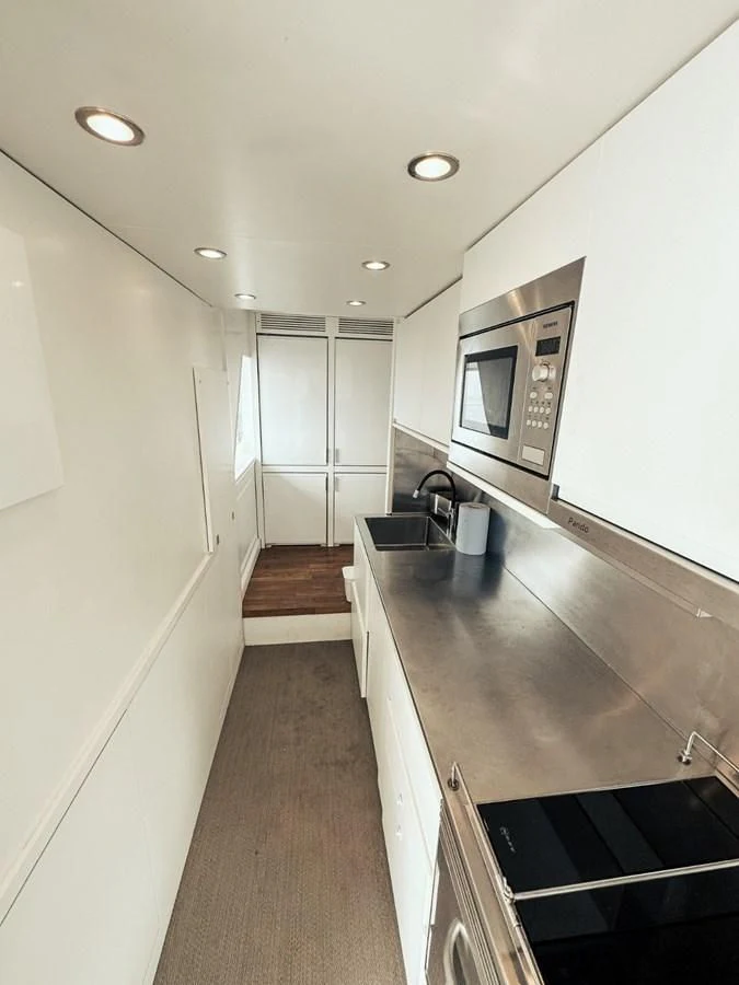 a long hallway with a large window aboard LAZIZA Yacht for Sale
