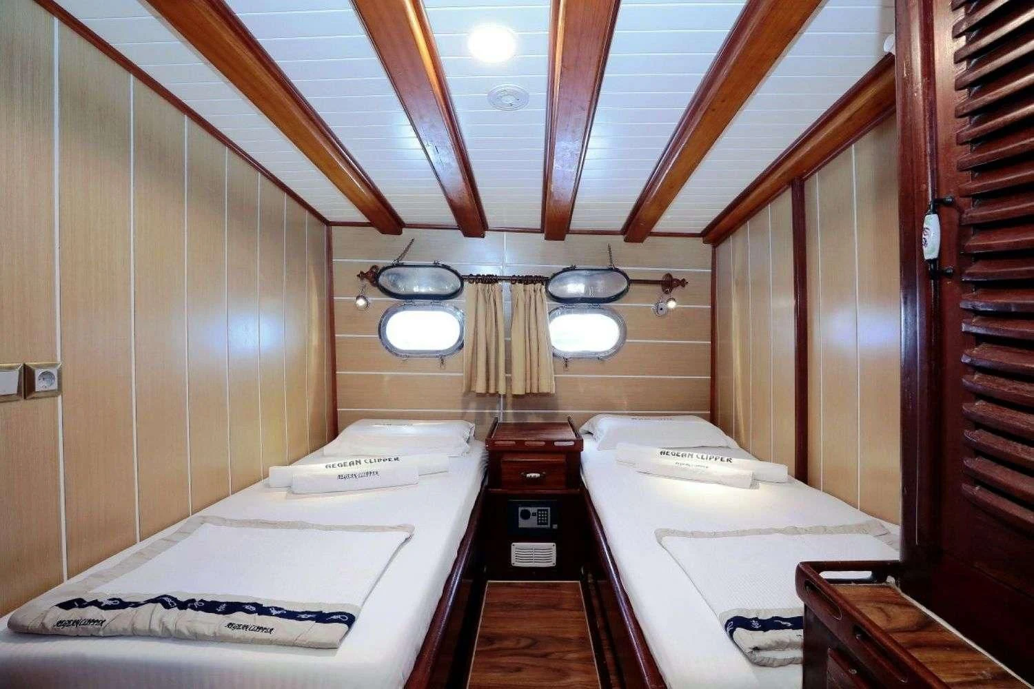a bathroom with a sink and a bed aboard AEGEAN CLIPPER Yacht for Sale