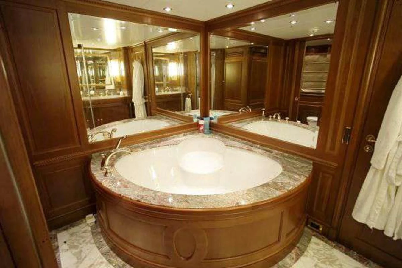 a bathroom with a large round mirror aboard LADY ANN Yacht for Sale