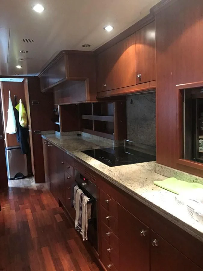 a kitchen with wooden cabinets aboard LADY ANN Yacht for Sale
