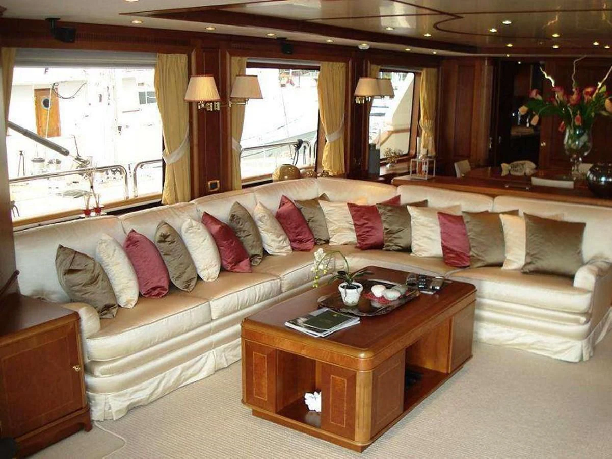 a living room with a couch and a coffee table aboard LADY ANN Yacht for Sale
