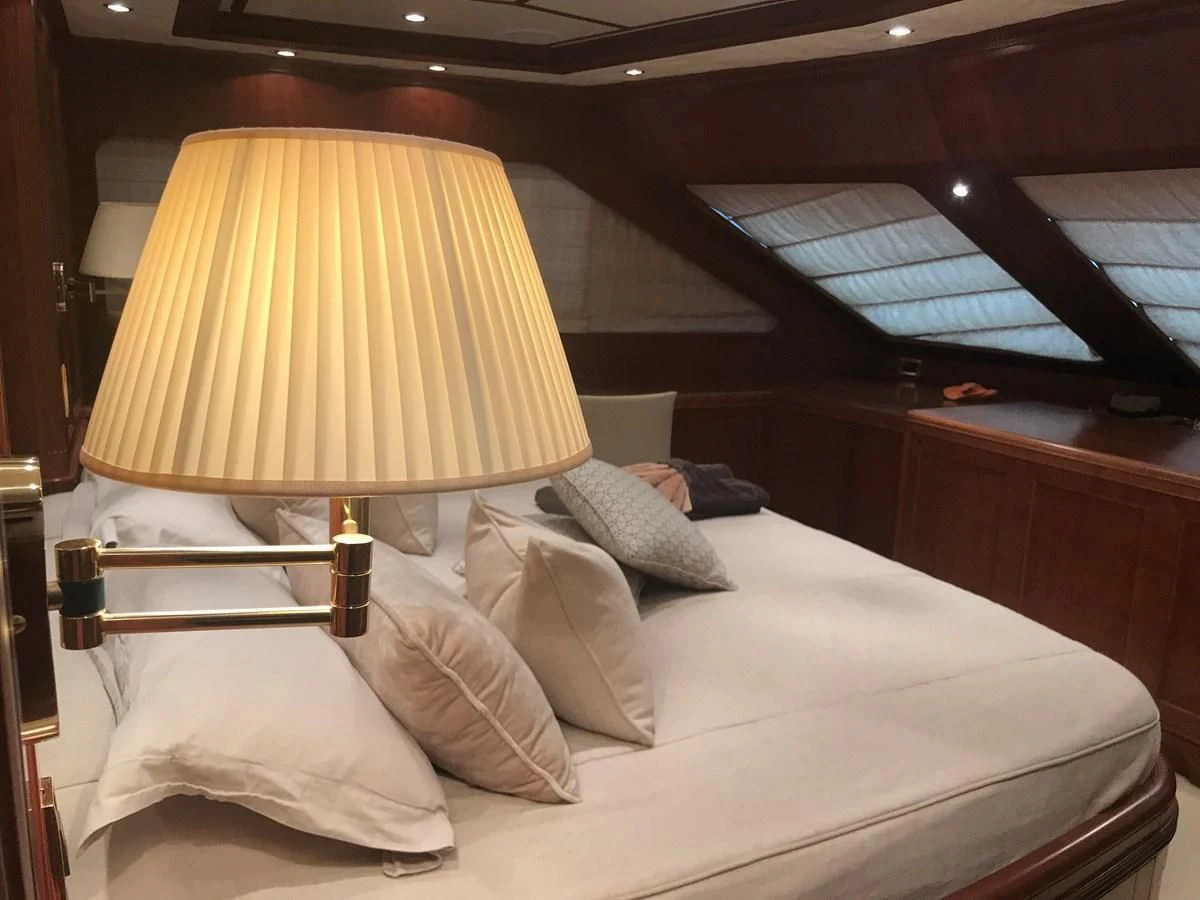 a bed with a lamp on it aboard LADY ANN Yacht for Sale