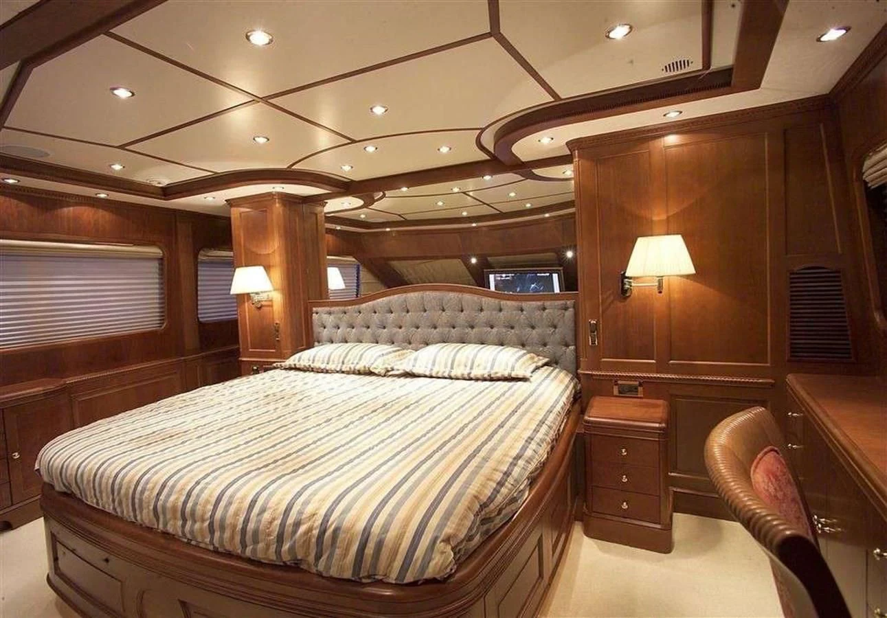 a bedroom with a bed and a lamp aboard LADY ANN Yacht for Sale