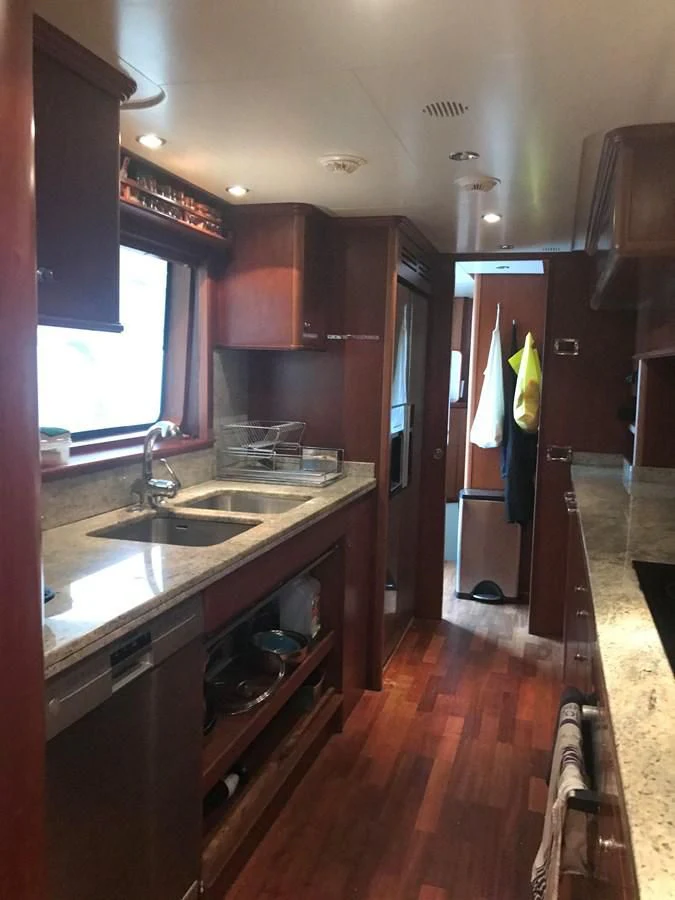 a kitchen with wooden cabinets aboard LADY ANN Yacht for Sale