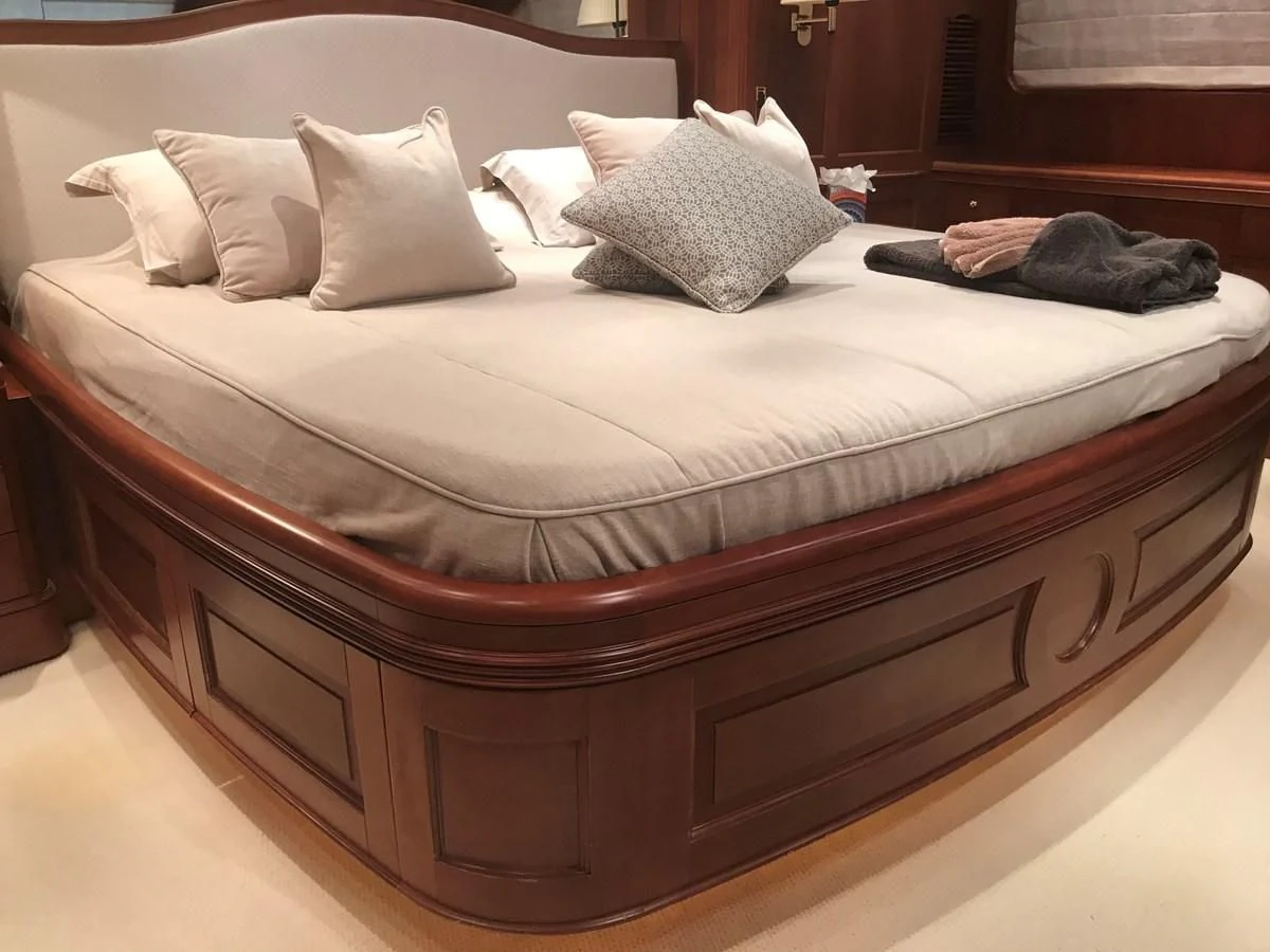 a bed with white sheets aboard LADY ANN Yacht for Sale