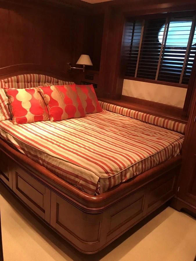 a bed with a colorful comforter aboard LADY ANN Yacht for Sale