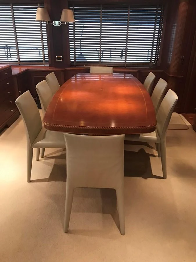 a wooden table with chairs aboard LADY ANN Yacht for Sale
