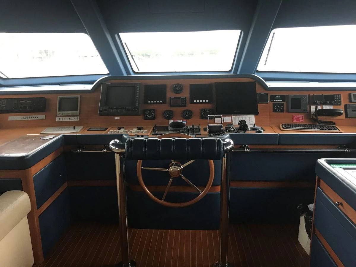 a room with a desk and chairs aboard LADY ANN Yacht for Sale