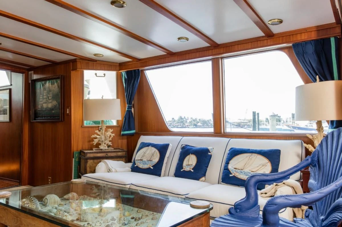 a living room with a blue couch aboard SEAFARI Yacht for Sale