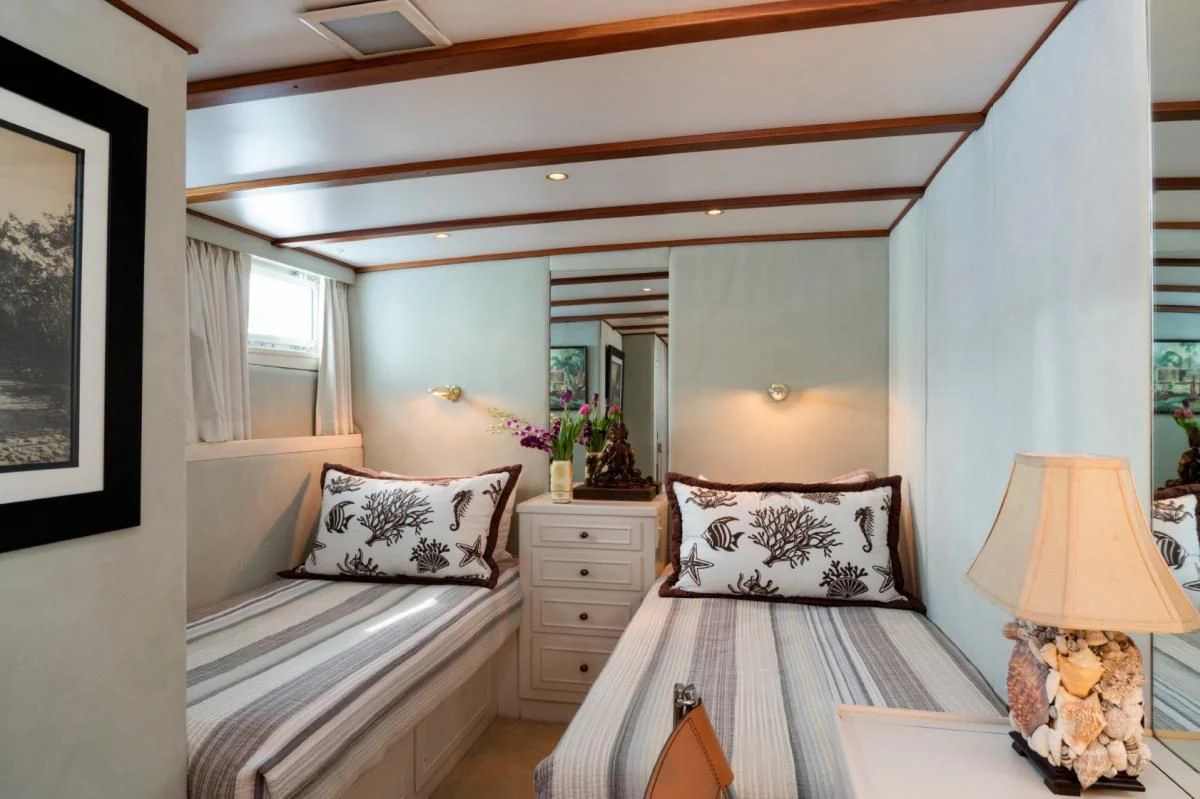 a bedroom with two beds aboard SEAFARI Yacht for Sale