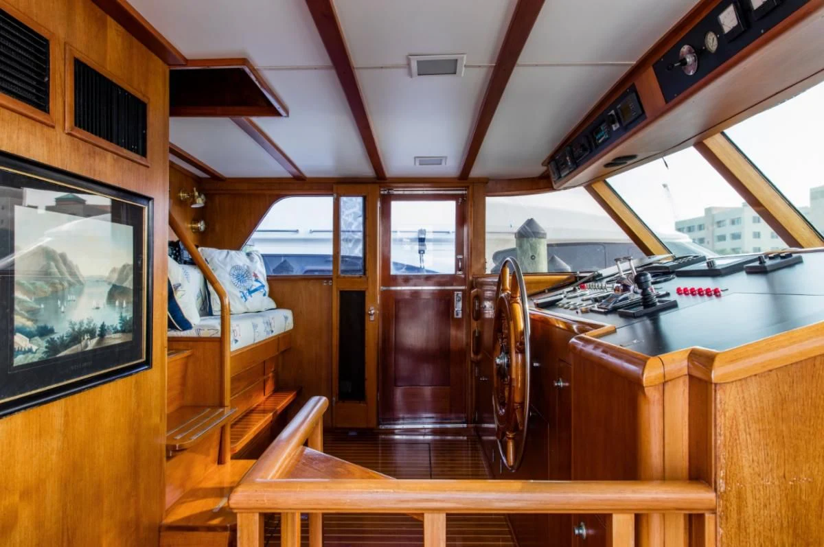 a kitchen with a table and chairs aboard SEAFARI Yacht for Sale