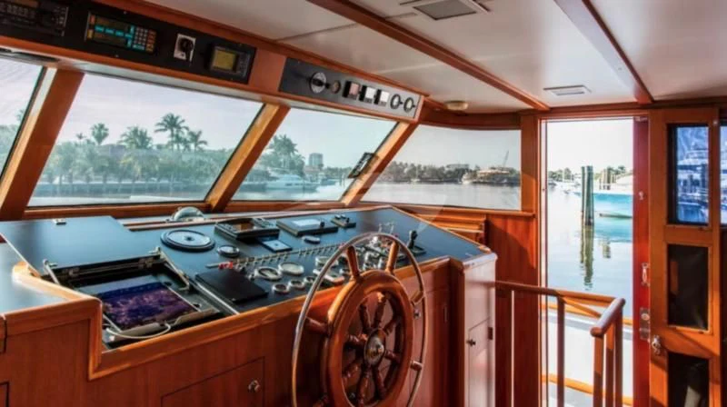 a wooden boat with a large wooden steering wheel aboard SEAFARI Yacht for Sale