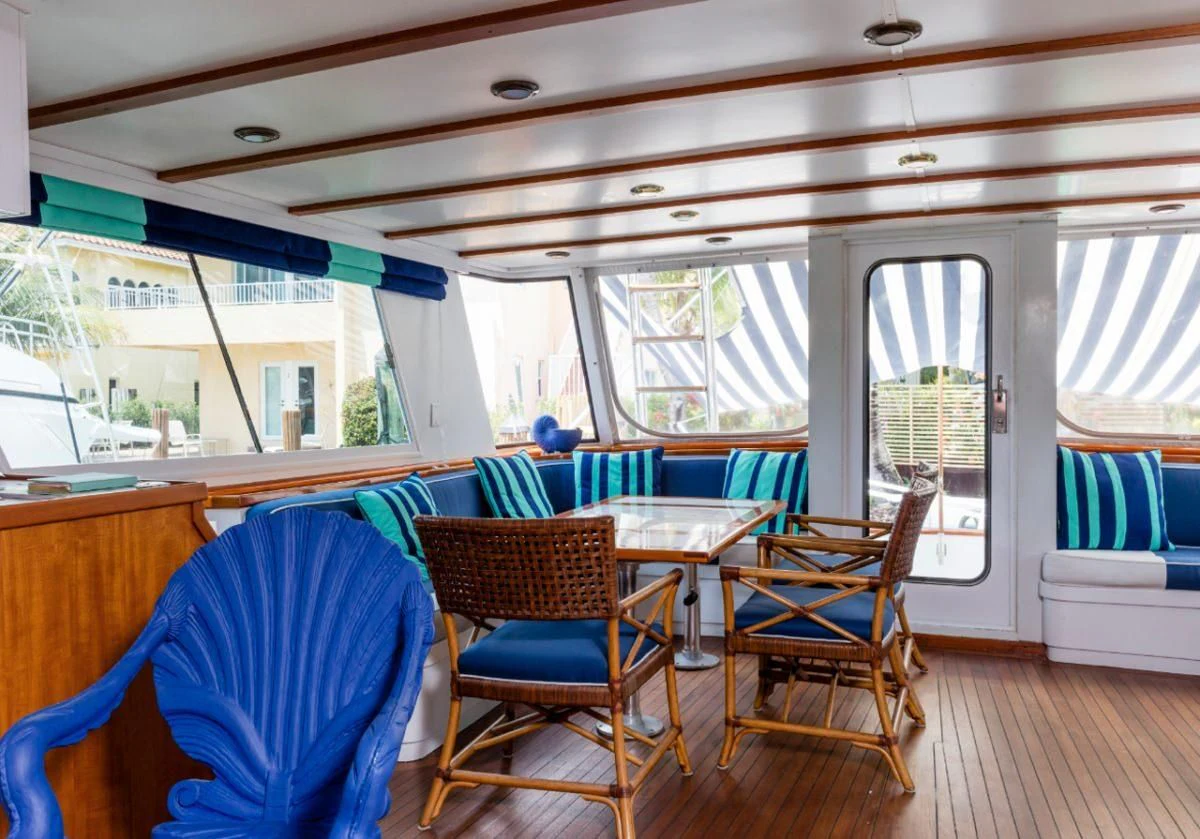 a boat with a table and chairs aboard SEAFARI Yacht for Sale