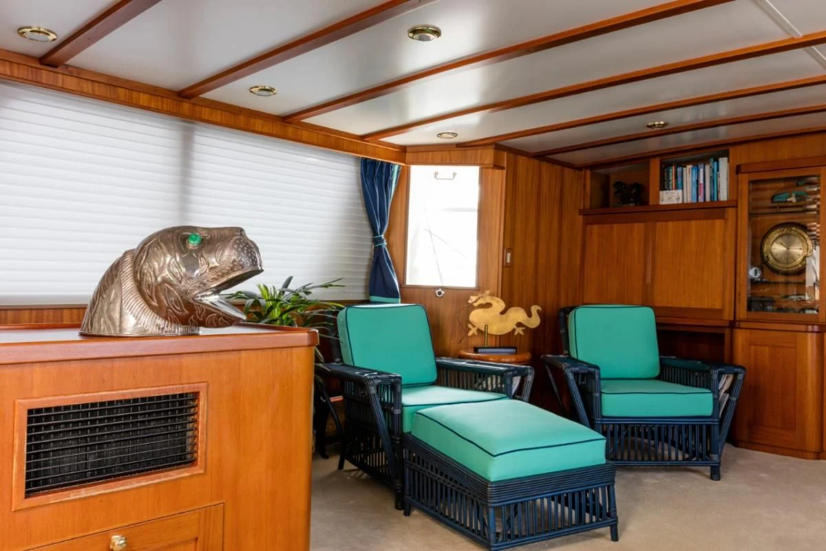 a living room with a couch and a television aboard SEAFARI Yacht for Sale