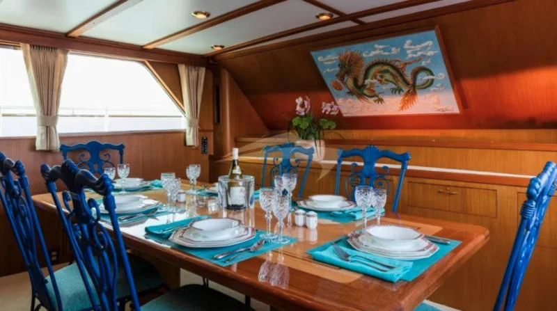 a dining table with plates and glasses aboard SEAFARI Yacht for Sale