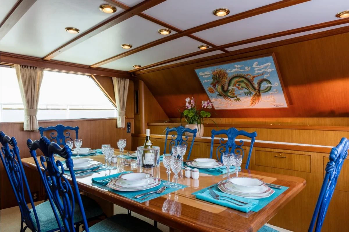 a dining room table set for a dinner party aboard SEAFARI Yacht for Sale
